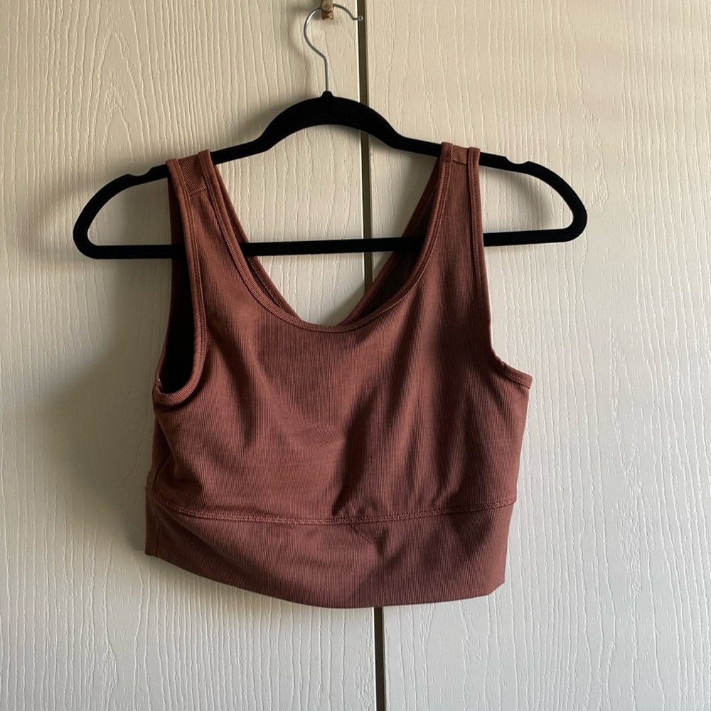 This is a pink crop workout top. It’s a size Medium and it has stripes.